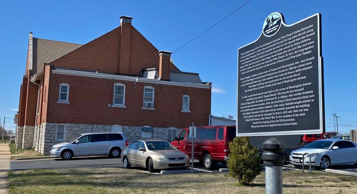 trail marker outside historic Gibson Chapel with the church in background